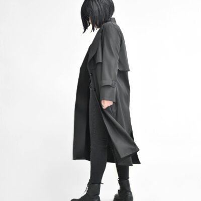 Anonymous model in stylish black apparel on white background